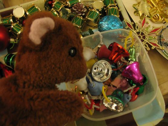Brown Teddy with a boxo full of bell Christmas decorations