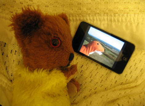 Yellow Teddy playing with the Ipod