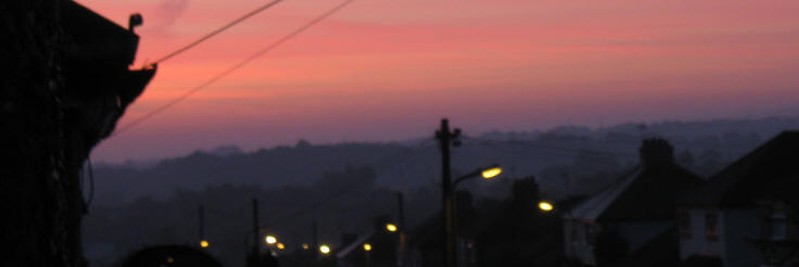 Dawn pink sky with street lamps