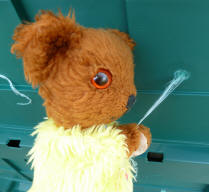 Yellow Teddy cutting off the plastic waste bits