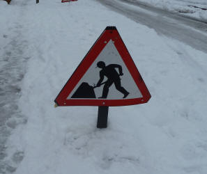 Shovelling road sign