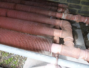 Hall Place radiator pipes in greenhouse