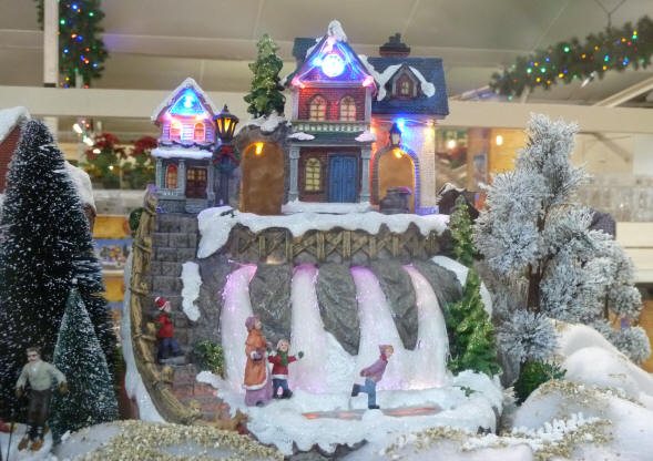 Christmas decorations - snowy village with waterfalls and skaters