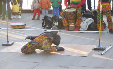 Street performers limbo dancing