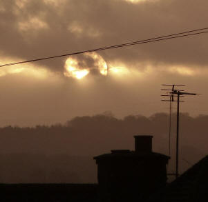 Clouds scudding over sun