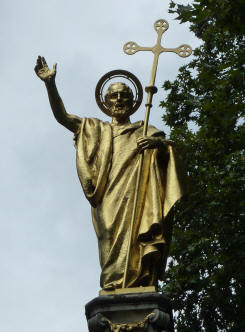 Golden statue of St Paul on top of monument